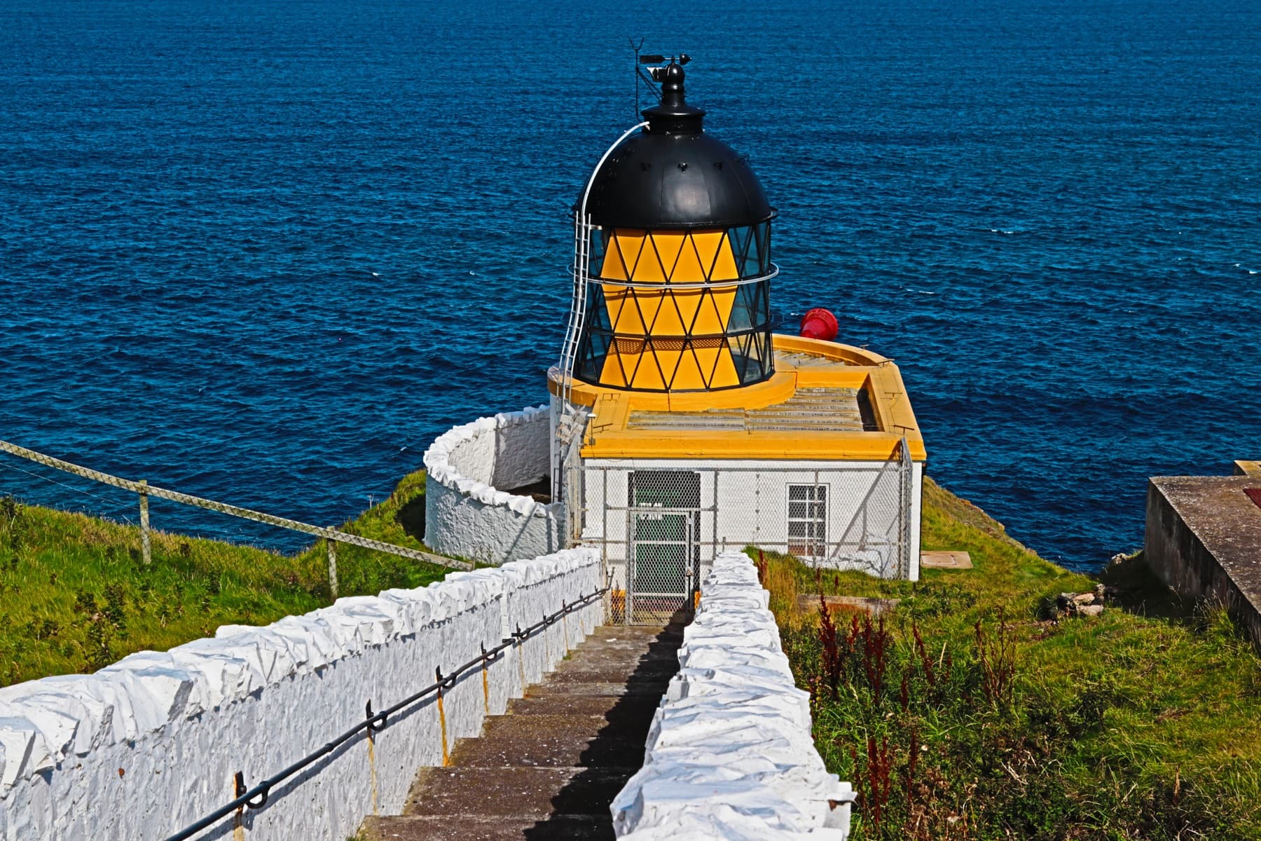 St Abbs Lighthouse above a blue coastal sea
